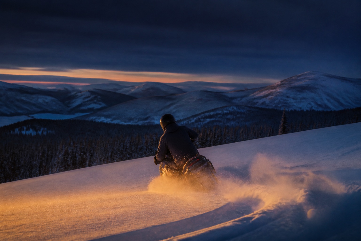A rider on an unbranded snowmobile carving powder on an unnamed ridgeline at blue hour