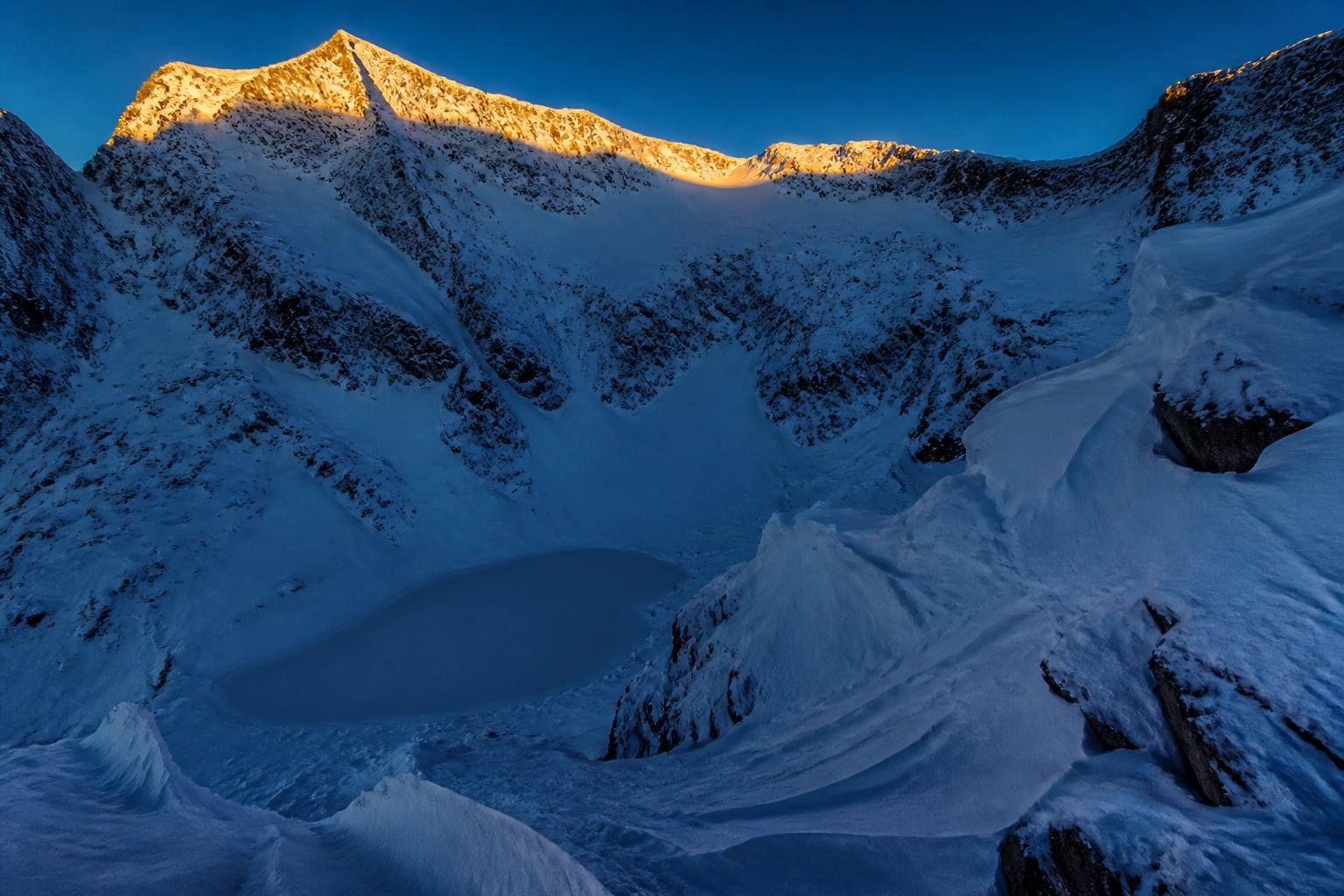 An unnamed alpine cirque at first light, no recognizable peak